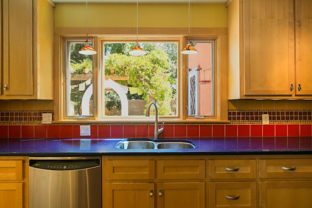 kitchen with pendant lighting, stainless steel dishwasher, sink, and decorative backsplash