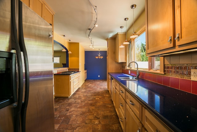 kitchen with pendant lighting, sink, appliances with stainless steel finishes, and tasteful backsplash