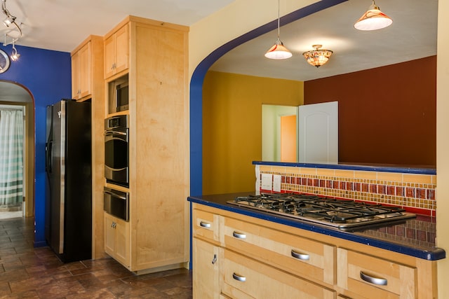 kitchen featuring backsplash, light brown cabinets, stainless steel appliances, and pendant lighting