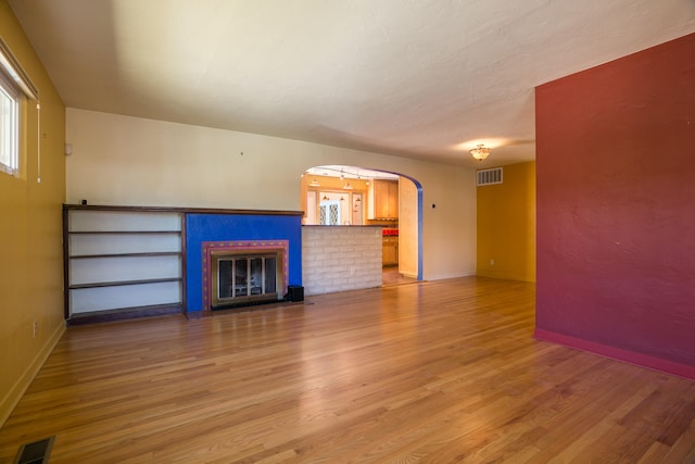 unfurnished living room featuring light hardwood / wood-style floors