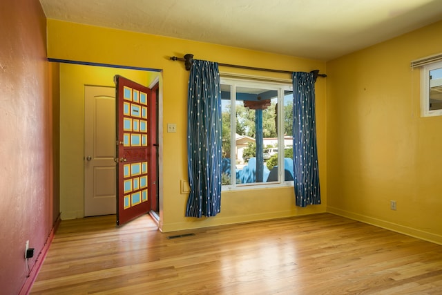 empty room with light hardwood / wood-style flooring