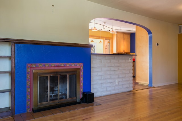 unfurnished living room with track lighting and hardwood / wood-style flooring