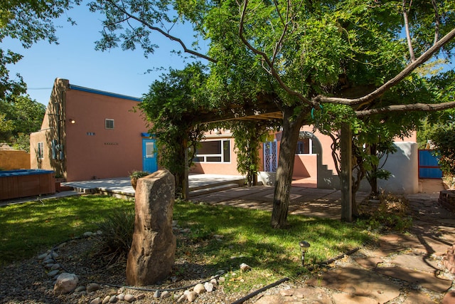 view of front facade with a patio area and a front yard