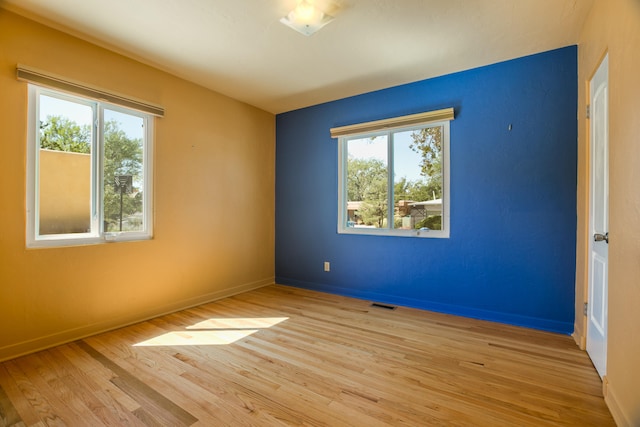 spare room featuring light hardwood / wood-style floors