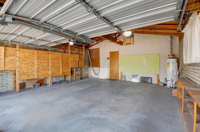 garage featuring water heater and a garage door opener