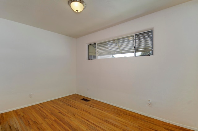 unfurnished room featuring hardwood / wood-style floors