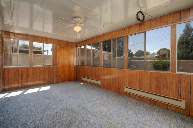 unfurnished sunroom featuring baseboard heating and ceiling fan