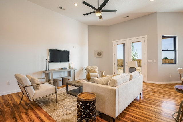 living room featuring french doors, hardwood / wood-style floors, ceiling fan, and vaulted ceiling