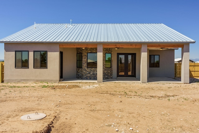 rear view of house with french doors, ceiling fan, and a patio