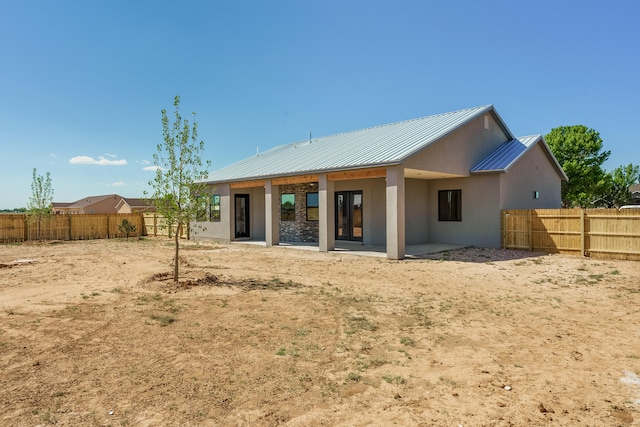 rear view of property featuring a patio area