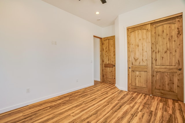 unfurnished bedroom featuring ceiling fan and light hardwood / wood-style floors