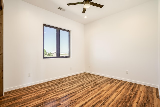 unfurnished room featuring ceiling fan and dark hardwood / wood-style floors