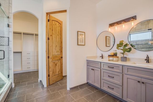 bathroom with vanity, tile patterned floors, and a shower with door