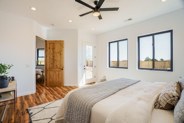 bedroom featuring dark hardwood / wood-style flooring, access to exterior, and ceiling fan