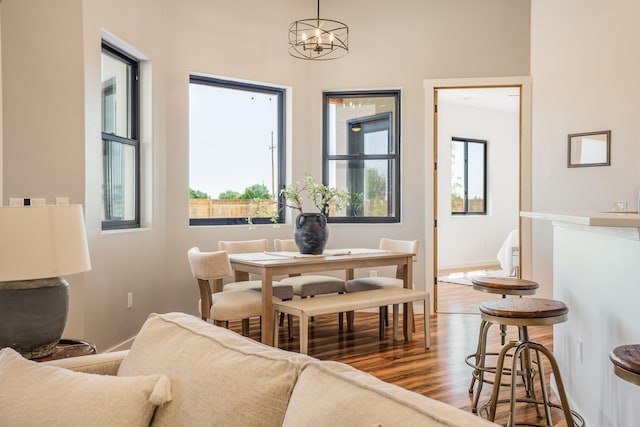 dining space featuring wood-type flooring and a chandelier