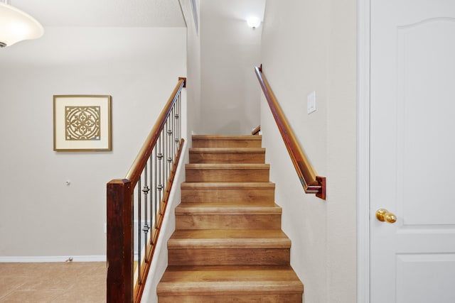 stairway with tile patterned flooring