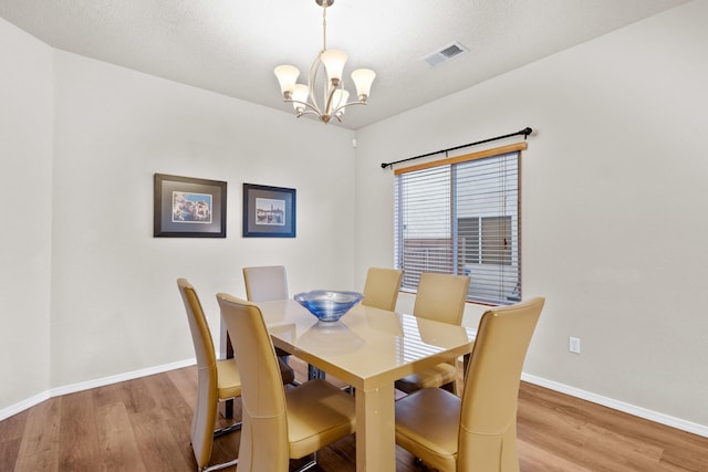 dining area featuring a chandelier and hardwood / wood-style floors