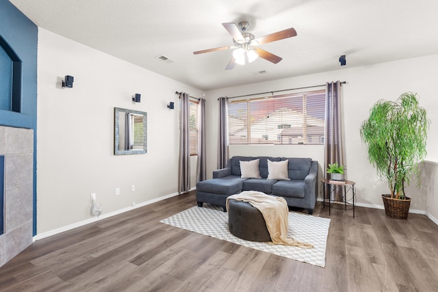 living room with ceiling fan and wood-type flooring