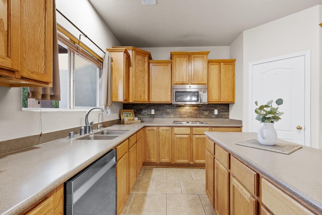 kitchen featuring appliances with stainless steel finishes, tasteful backsplash, sink, and light tile patterned floors