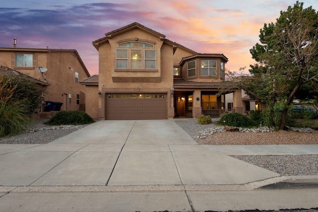 front of property featuring covered porch and a garage