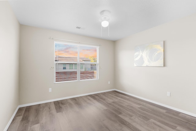 unfurnished bedroom featuring electric panel, light hardwood / wood-style flooring, and a closet