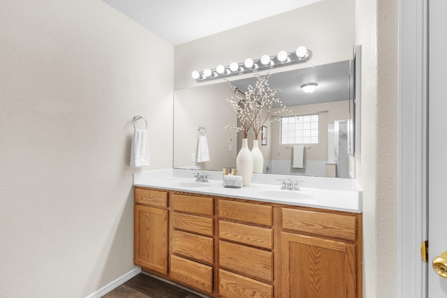 bathroom with vanity, a textured ceiling, and hardwood / wood-style flooring