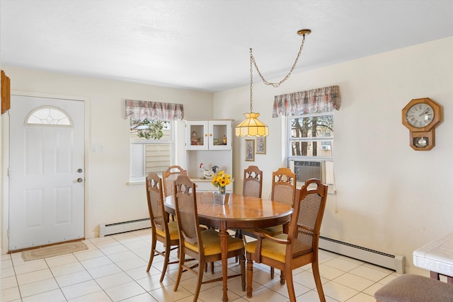 tiled dining area featuring cooling unit, baseboard heating, and a healthy amount of sunlight