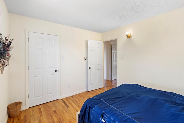 bedroom featuring a textured ceiling and hardwood / wood-style floors