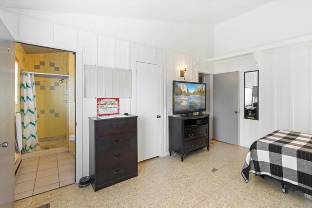 bedroom with connected bathroom and vaulted ceiling