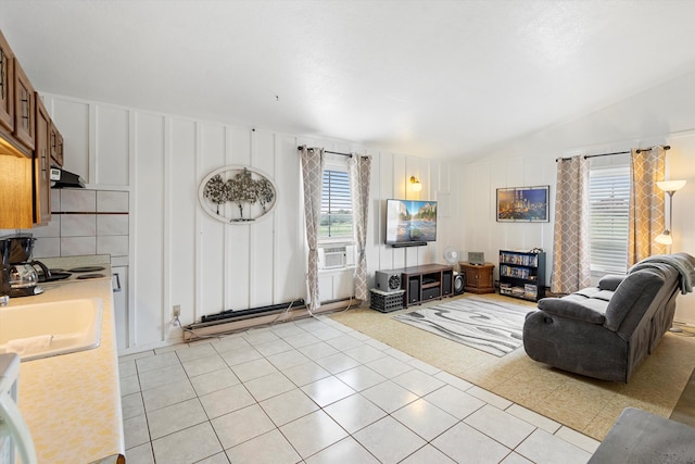 tiled living room with cooling unit, lofted ceiling, and sink