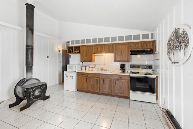 kitchen with light tile patterned flooring, sink, decorative backsplash, high vaulted ceiling, and white appliances