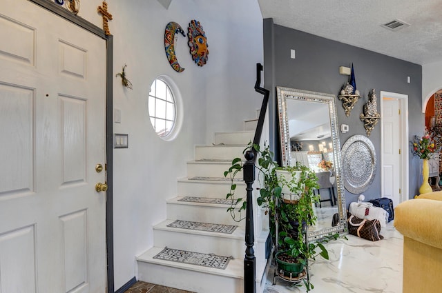 entrance foyer featuring a textured ceiling