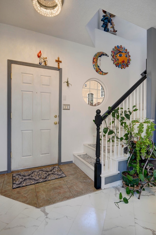 foyer entrance featuring a textured ceiling