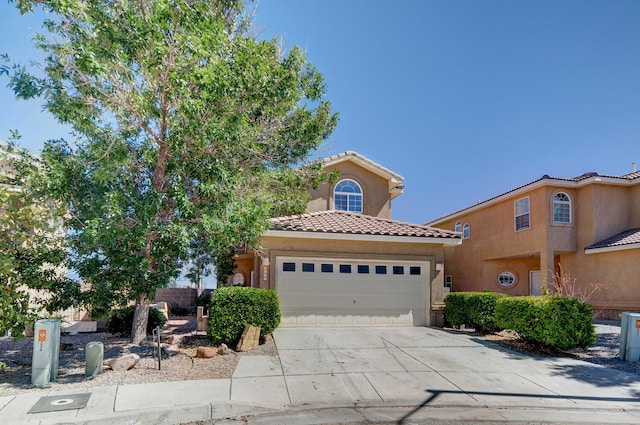 mediterranean / spanish house featuring a garage