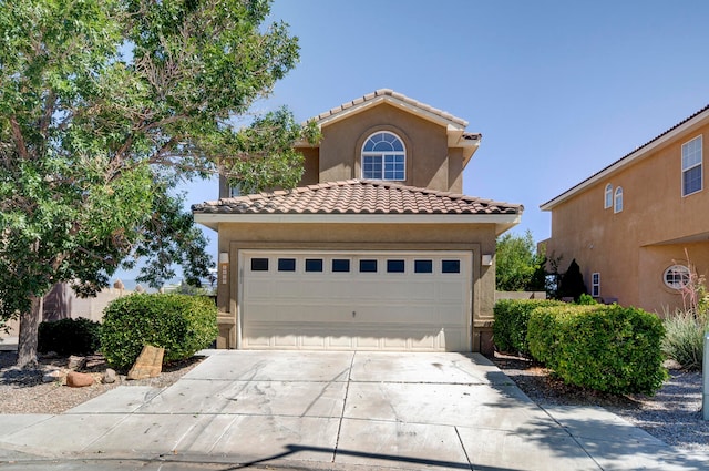 mediterranean / spanish home featuring a garage