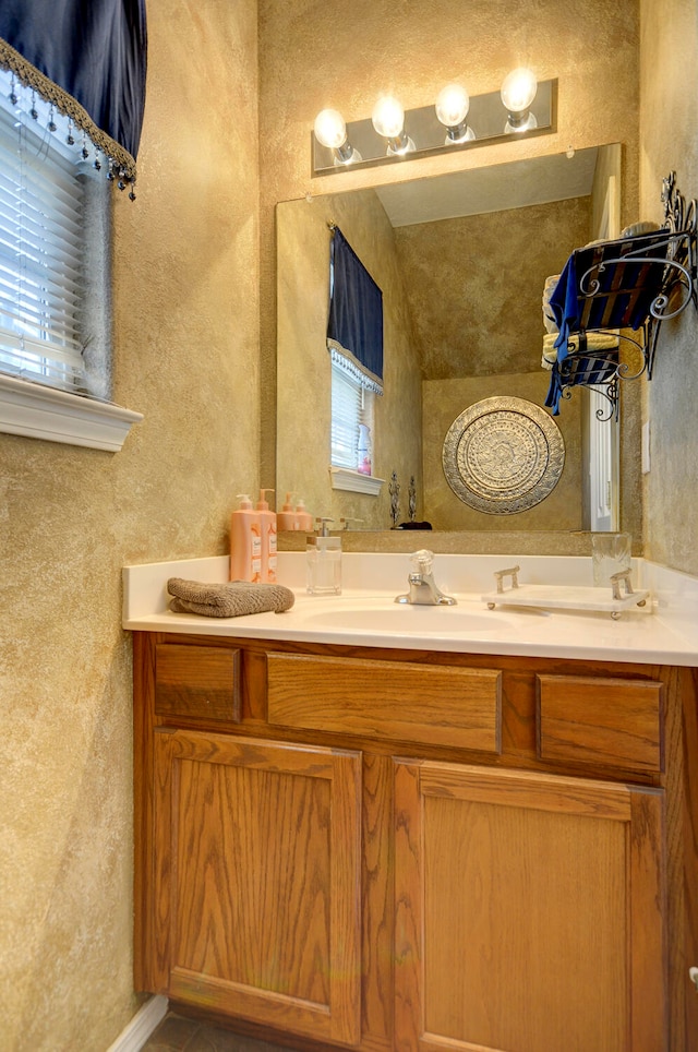 bathroom with vanity and vaulted ceiling