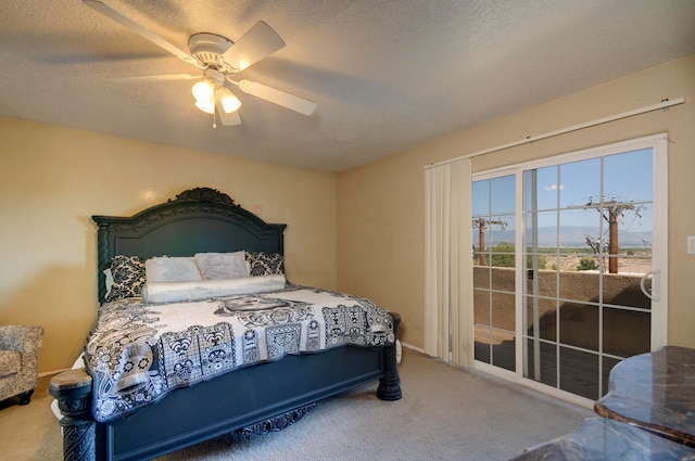 carpeted bedroom with ceiling fan and a textured ceiling