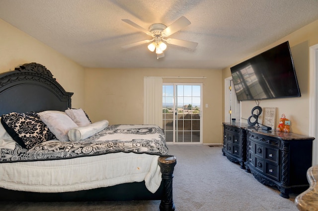 carpeted bedroom with ceiling fan and a textured ceiling