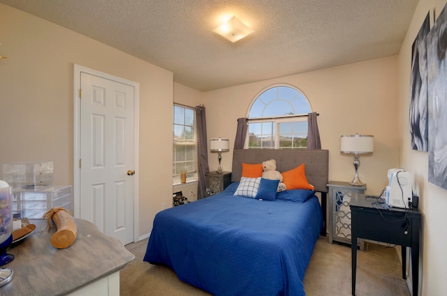 carpeted bedroom with a textured ceiling