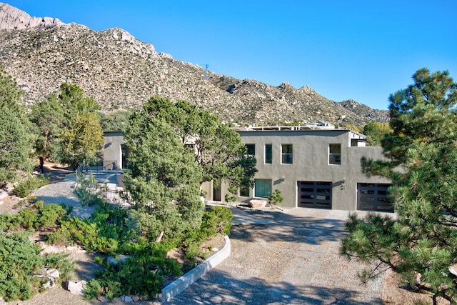 view of front of home featuring a garage and a mountain view