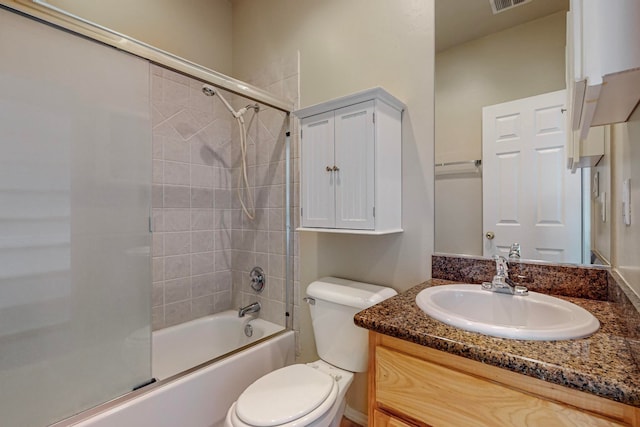 full bathroom with vanity, tiled shower / bath combo, and toilet