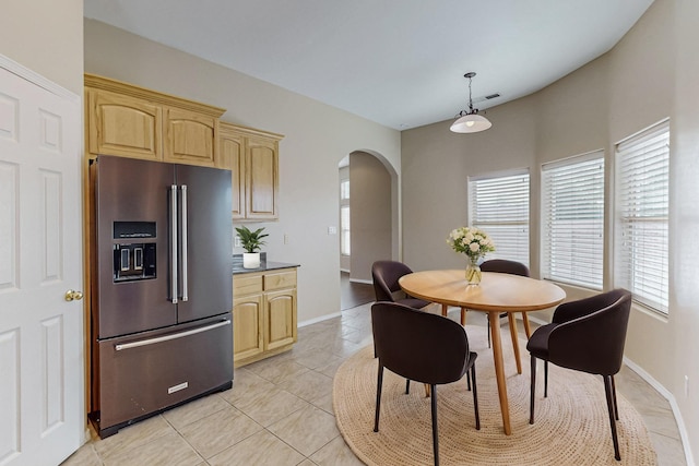 4629 Spanish Sun Ave NE, Albuquerque, NM 87109 - dining space with arched walkways, baseboards, light tile patterned floors, and plenty of natural light