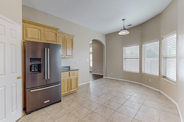 4629 Spanish Sun Ave NE, Albuquerque, NM 87109 - kitchen with light tile patterned floors, baseboards, arched walkways, light brown cabinets, and high quality fridge