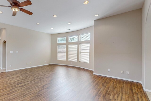 spare room with ceiling fan and dark hardwood / wood-style flooring