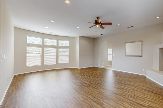 4629 Spanish Sun Ave NE, Albuquerque, NM 87109 - unfurnished living room featuring a ceiling fan, wood finished floors, visible vents, arched walkways, and recessed lighting