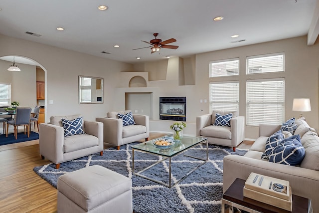 living room with hardwood / wood-style floors and ceiling fan