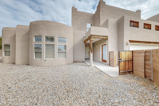 4629 Spanish Sun Ave NE, Albuquerque, NM 87109 - rear view of house with a patio area, a gate, fence, and stucco siding