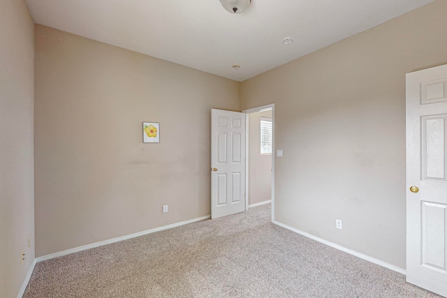 unfurnished room with light carpet