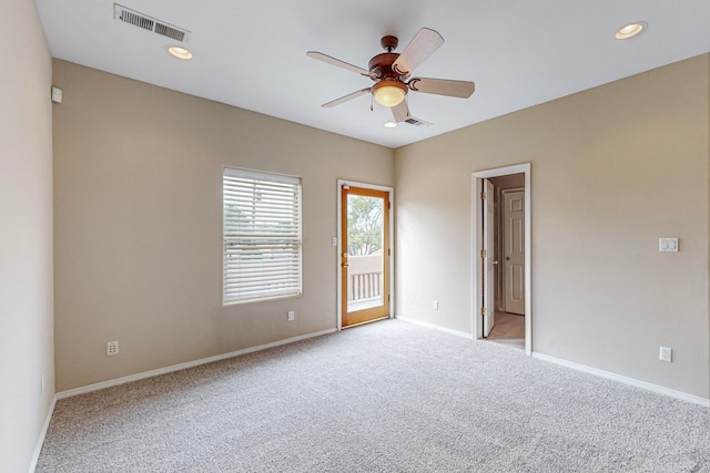 carpeted empty room featuring ceiling fan