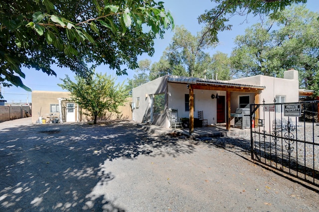 pueblo-style house featuring a patio area